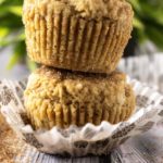 Gingerbread Muffins kept on each other with the liner opened and brown sugar in front