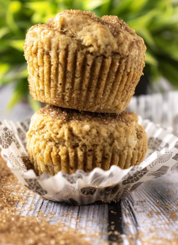 Gingerbread Muffins kept on each other with the liner opened and brown sugar in front