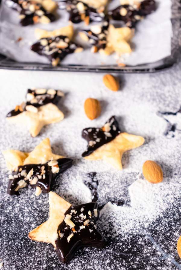 Holiday Shortbread Star Shaped Cookies arranged on a black table