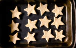 Holiday Shortbread Star Shaped Cookies arranged on a baking tray