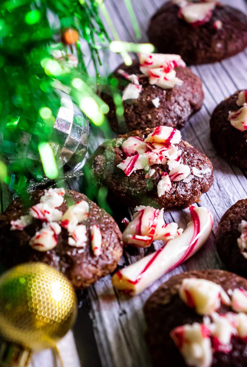 Peppermint Mocha Cookies arranged with candy canes and christmas tree on the left