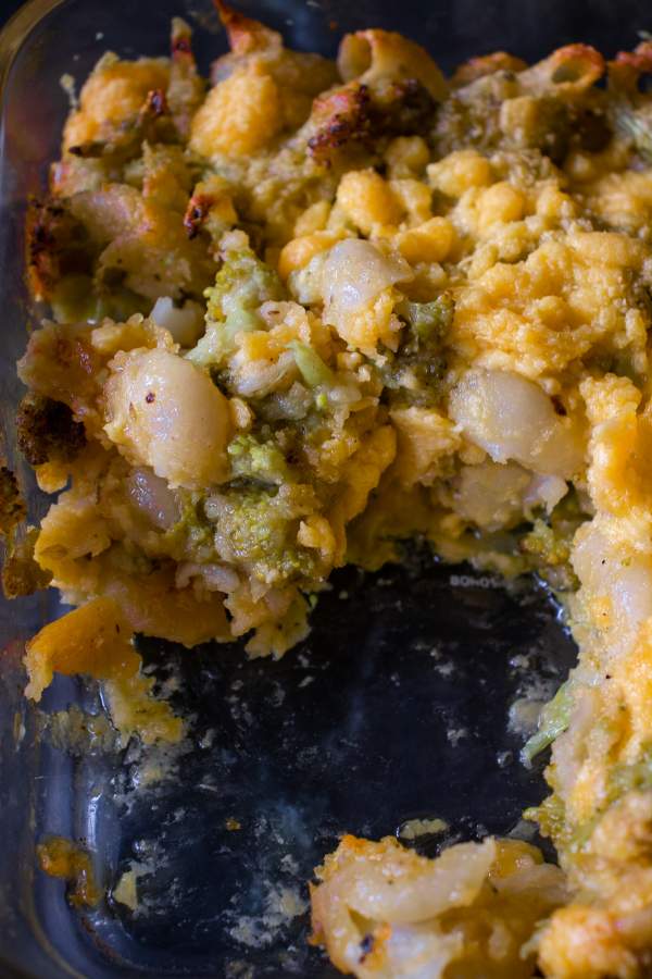 broccoli mac and cheese in a casserole dish with half eaten